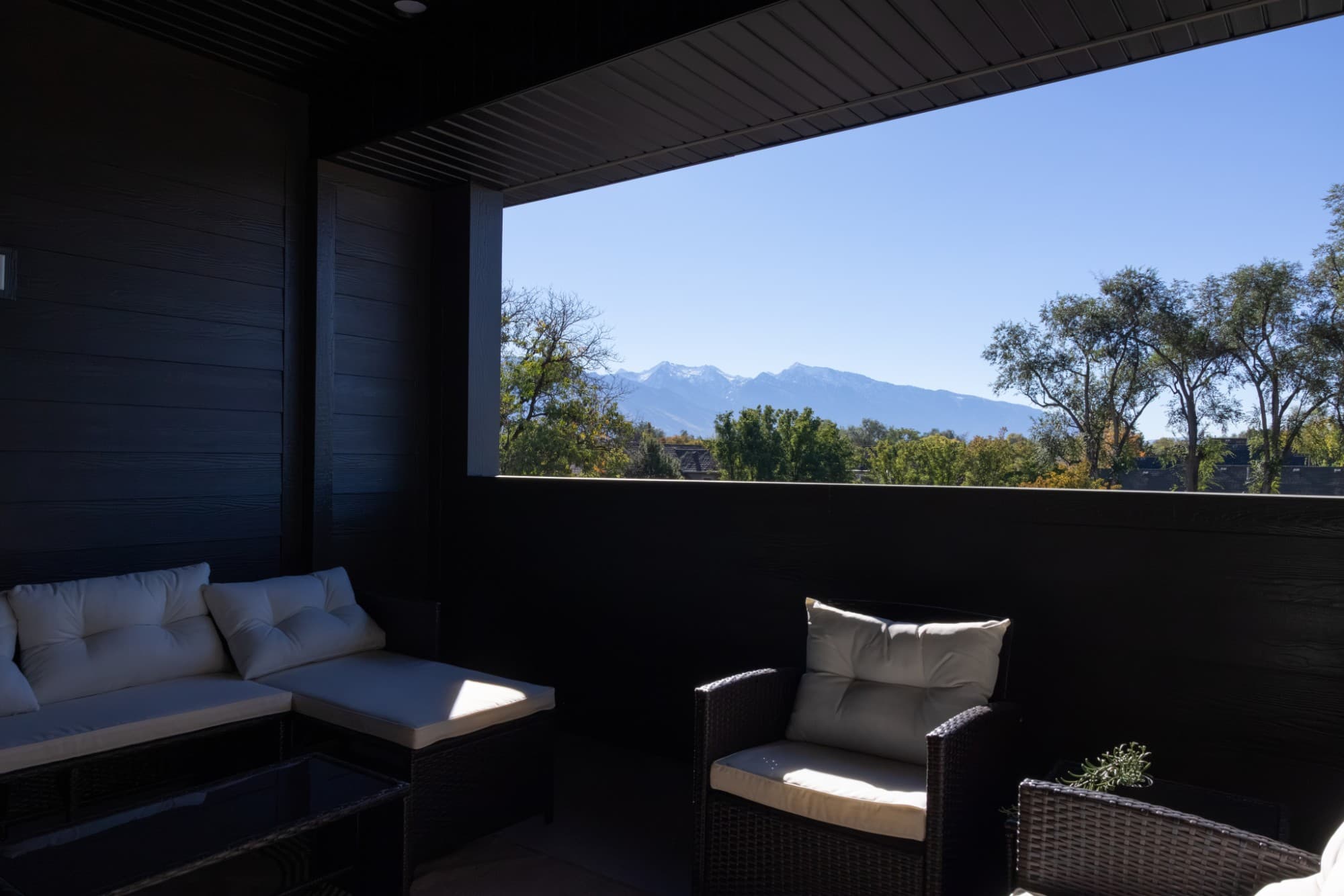 Covered rooftop patio with mountain views
